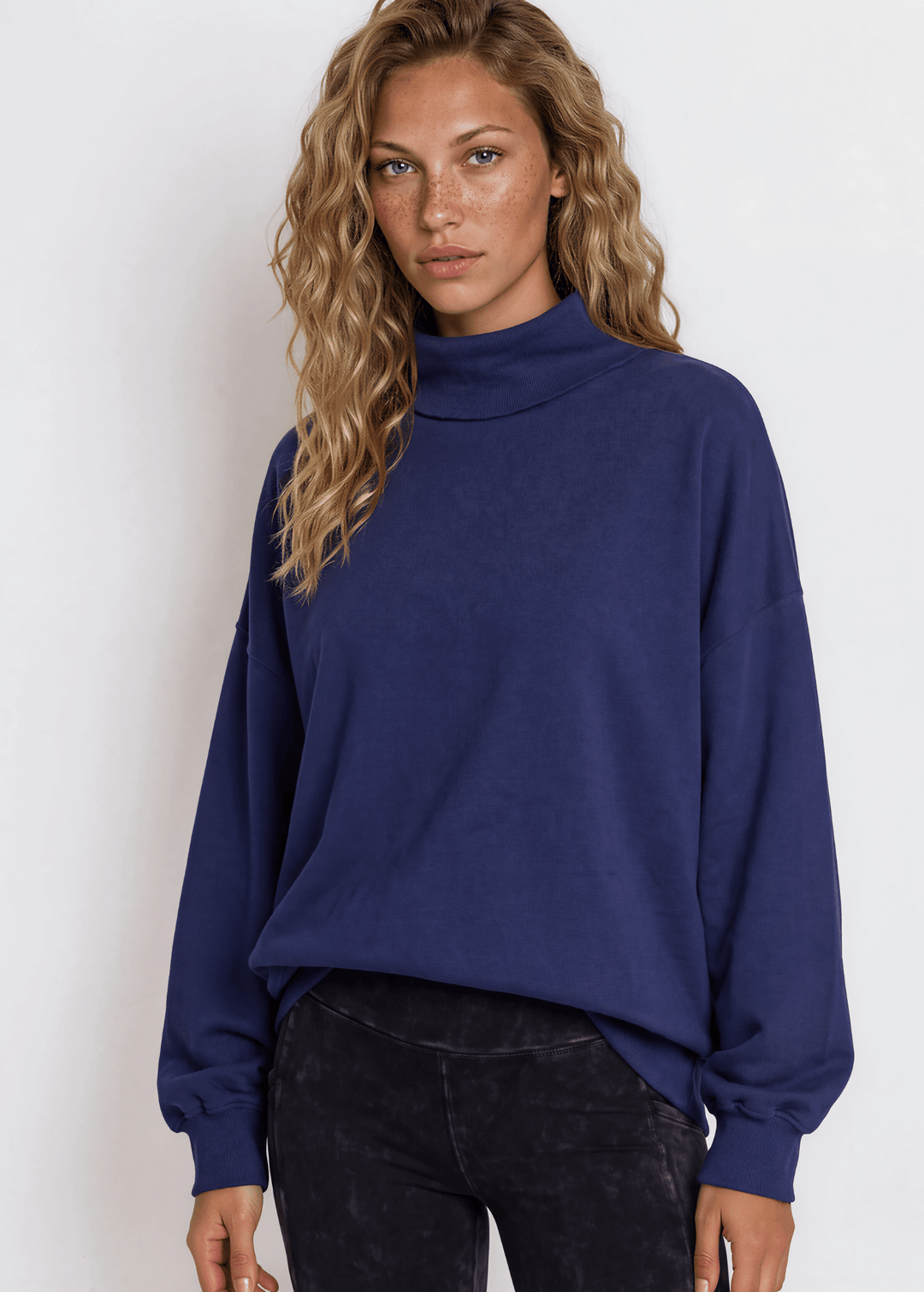 Cozy oversized women's mock neck sweatshirt in navy. Drop shoulder, ribbed cuffs, super soft fabric. Made in USA. Sizes S–L.