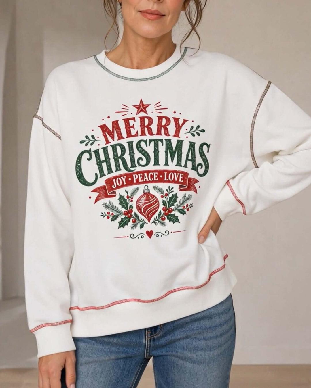 Women's white crewneck sweatshirt with contrast stitching featuring the Vintage Christmas Joy Peace Love design, front close-up, hand on hip, Made in USA