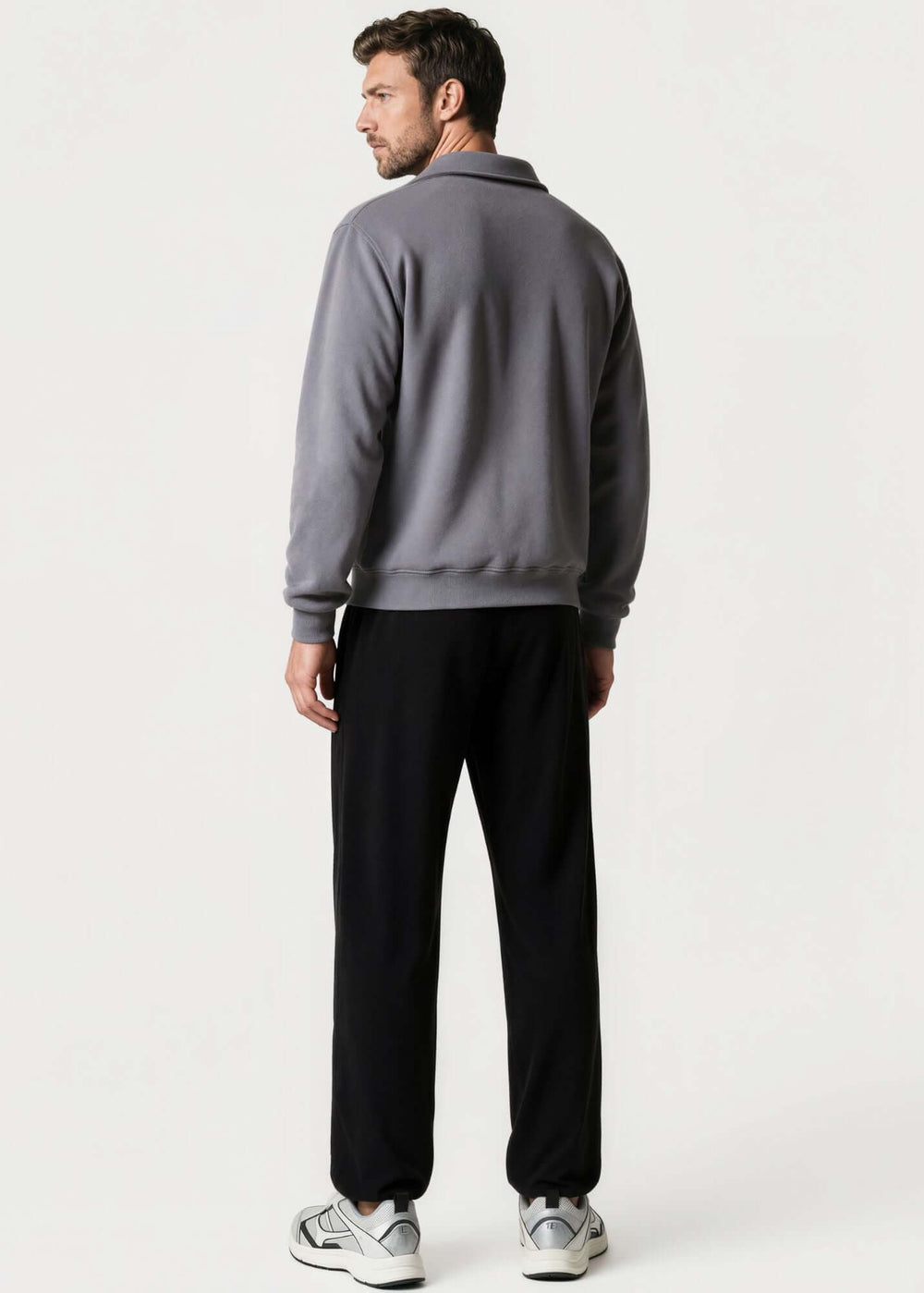 Made in USA men's cotton True American grey quarter-zip pullover with a stand collar, long sleeves, ribbed cuffs and hem, shown on a male model.