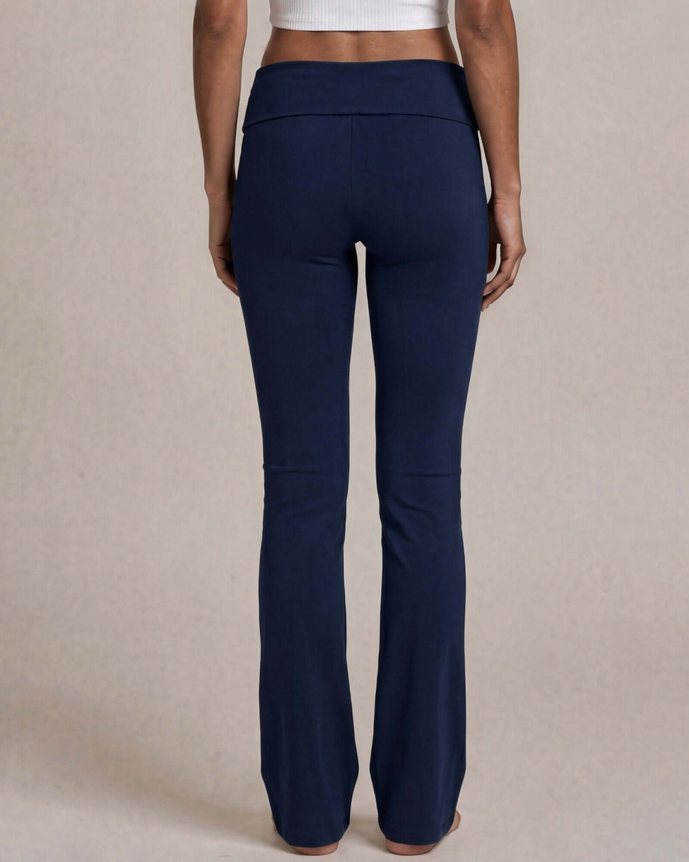 Made in USA women's navy cotton spandex yoga pant with wide waistband and slight flare leg, side view