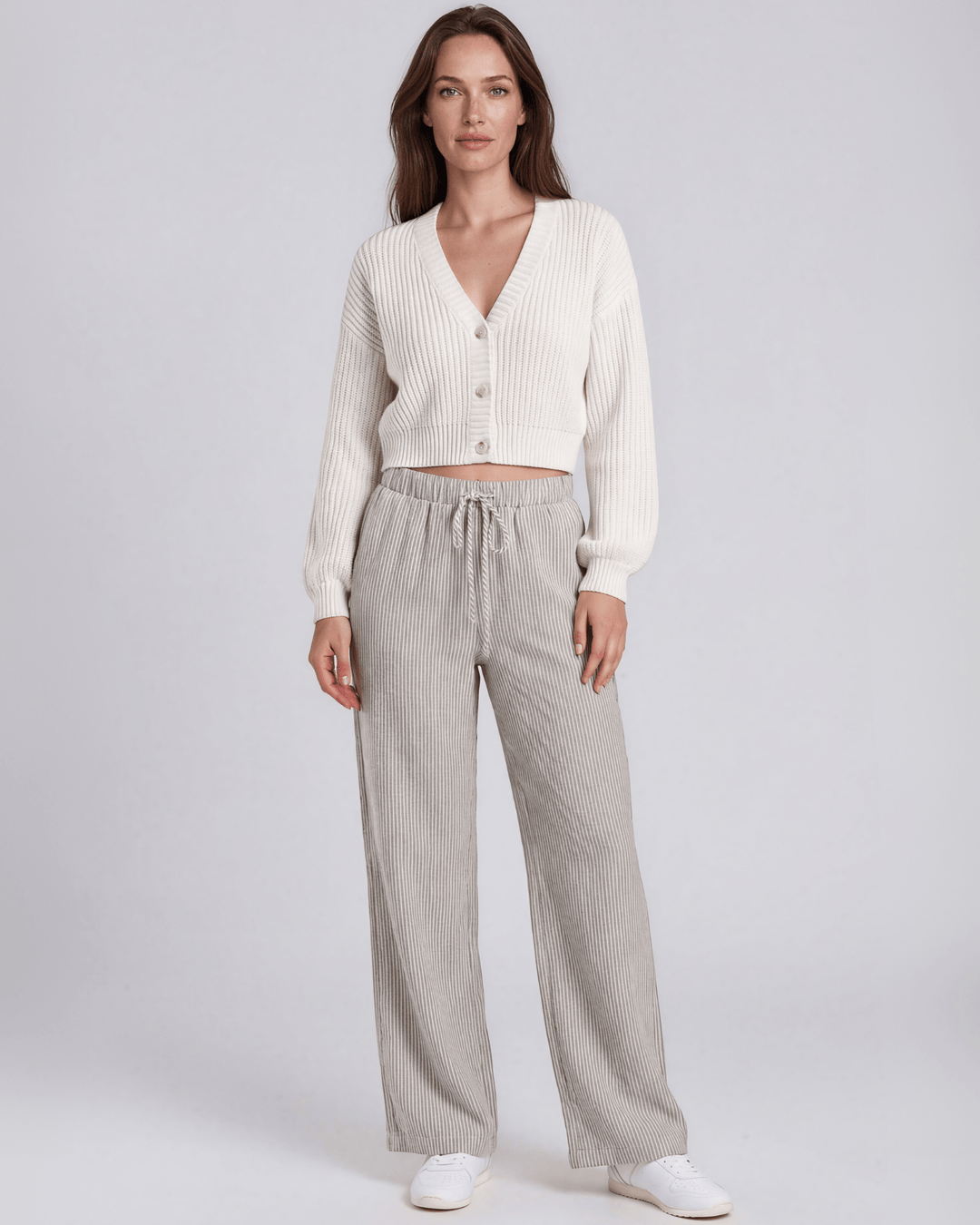 Charcoal and off-white vertical pinstripe seersucker wide leg pants with a soft crinkled texture, elastic drawstring waistband, and side pockets in a relaxed flowy silhouette. Made in USA