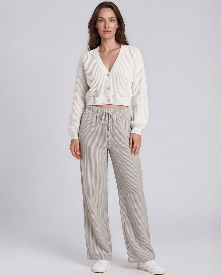 Charcoal and off-white vertical pinstripe seersucker wide leg pants with a soft crinkled texture, elastic drawstring waistband, and side pockets in a relaxed flowy silhouette. Made in USA