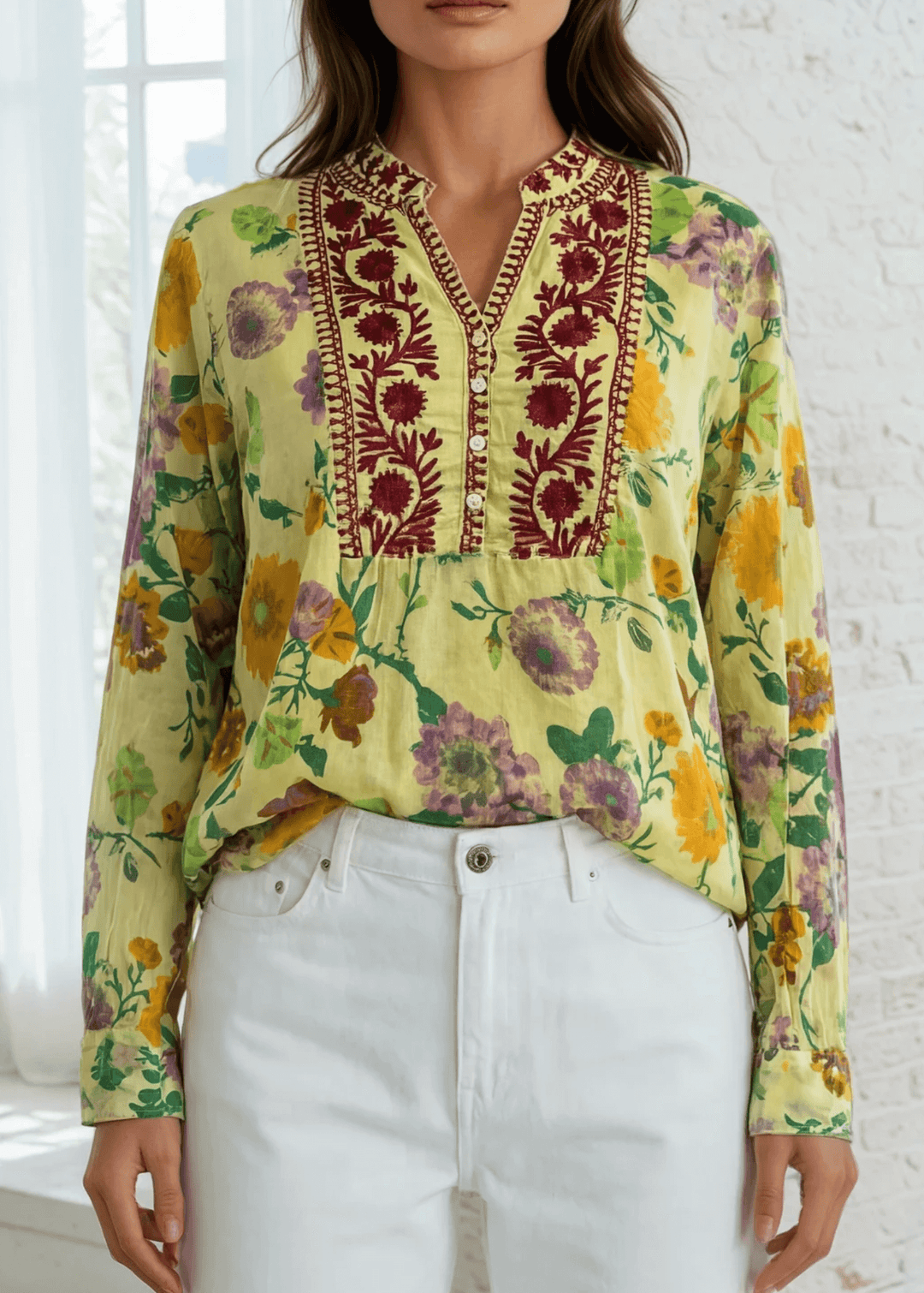 Bask in the beauty of effortless bohemian charm with the Carla Top. Crafted from soft, breathable cotton voile, this piece features a vibrant floral print in sun-kissed tones of golden marigold, lilac, and fresh green. The hand-embroidered deep red bib adds an artisanal touch, making each blouse unique. Designed with a relaxed silhouette and a flattering V-neckline, it's perfect for warm days or layered looks. Made in Los Angeles and finished with a light garment-dye wash for a soft, lived-in feel. 