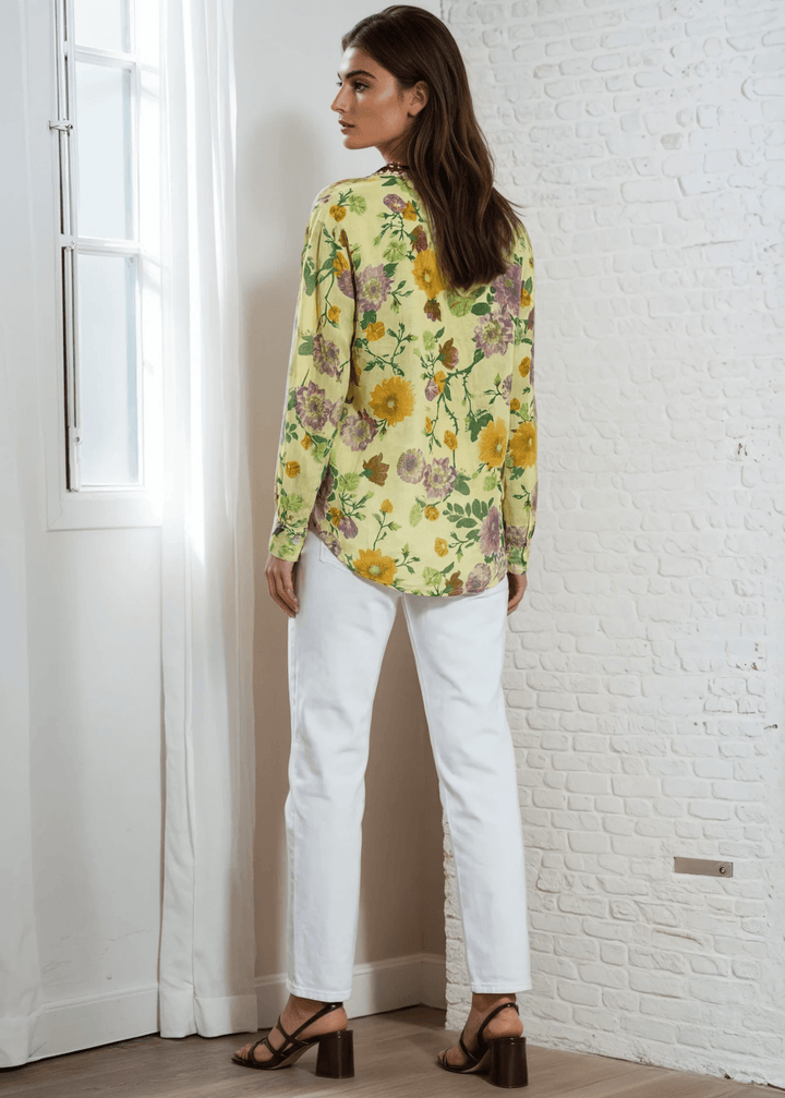 Bask in the beauty of effortless bohemian charm with the Carla Top. Crafted from soft, breathable cotton voile, this piece features a vibrant floral print in sun-kissed tones of golden marigold, lilac, and fresh green. The hand-embroidered deep red bib adds an artisanal touch, making each blouse unique. Designed with a relaxed silhouette and a flattering V-neckline, it's perfect for warm days or layered looks. Made in Los Angeles and finished with a light garment-dye wash for a soft, lived-in feel. 