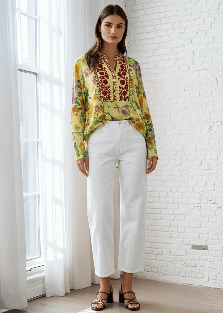 Bask in the beauty of effortless bohemian charm with the Carla Top. Crafted from soft, breathable cotton voile, this piece features a vibrant floral print in sun-kissed tones of golden marigold, lilac, and fresh green. The hand-embroidered deep red bib adds an artisanal touch, making each blouse unique. Designed with a relaxed silhouette and a flattering V-neckline, it's perfect for warm days or layered looks. Made in Los Angeles and finished with a light garment-dye wash for a soft, lived-in feel. 