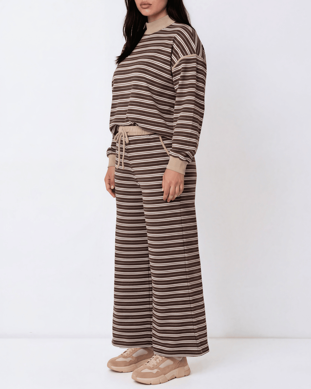 Made in USA plus size women's brown and taupe striped wide leg ankle length drawstring lounge pants with side pockets paired with Striped matching top, close-up front view