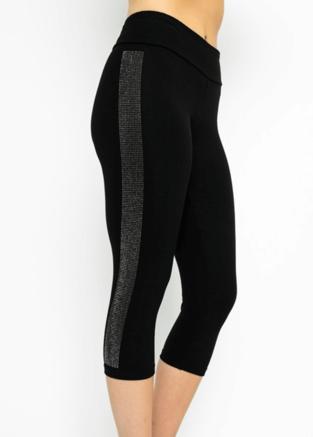 Meet the Carmen Capri Leggings in Black—American-made quality you can feel the difference in. These sleek black capris feature a striking side stripe embellished with shimmering stones, adding just the right touch of glamour to your everyday look.