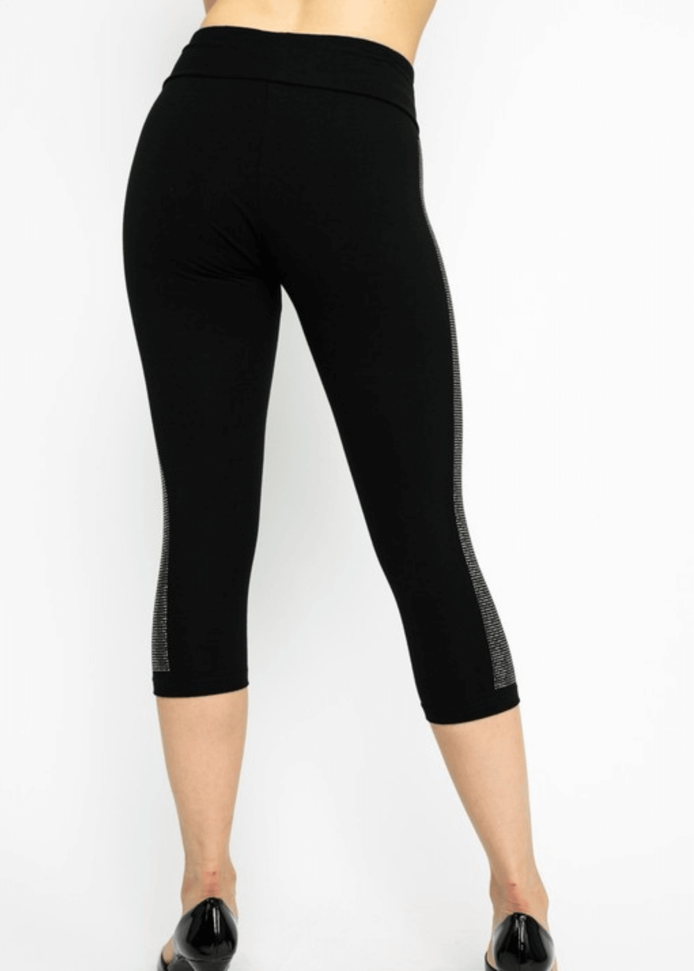 Meet the Carmen Capri Leggings in Black—American-made quality you can feel the difference in. These sleek black capris feature a striking side stripe embellished with shimmering stones, adding just the right touch of glamour to your everyday look.