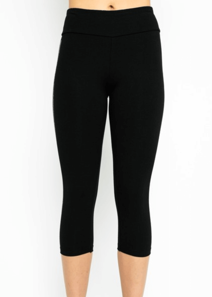 Meet the Carmen Capri Leggings in Black—American-made quality you can feel the difference in. These sleek black capris feature a striking side stripe embellished with shimmering stones, adding just the right touch of glamour to your everyday look.