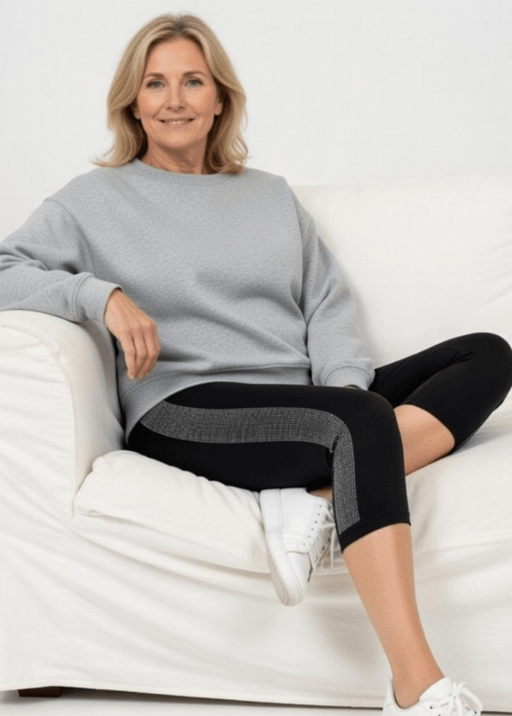 Meet the Carmen Capri Leggings in Black—American-made quality you can feel the difference in. These sleek black capris feature a striking side stripe embellished with shimmering stones, adding just the right touch of glamour to your everyday look.