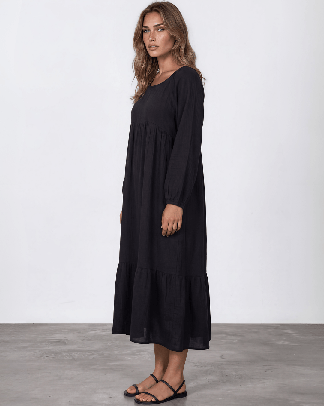 Black Cotton Gauze Maxi Dress. Scoop neck,  empire waist, long billowy sleeves, tiered ruffle hem, 100% cotton. S–XL. Made in USA.