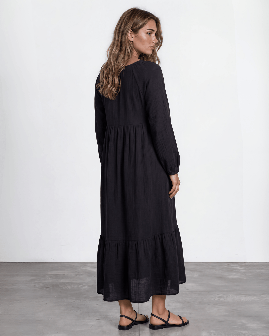 Black Cotton Gauze Maxi Dress. Scoop neck,  empire waist, long billowy sleeves, tiered ruffle hem, 100% cotton. S–XL. Made in USA.
