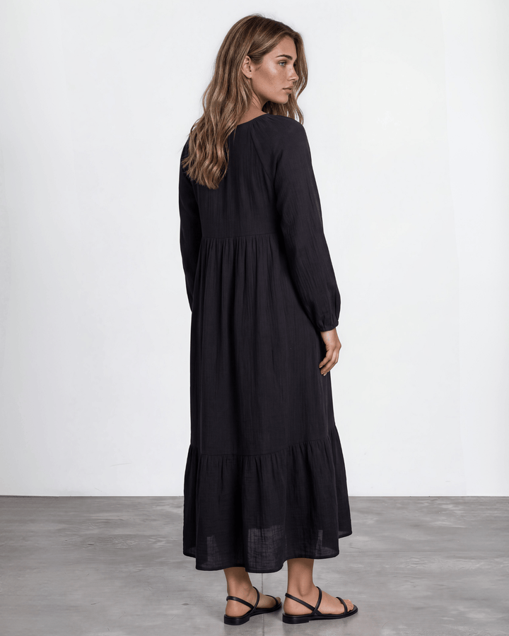 Black Cotton Gauze Maxi Dress. Scoop neck,  empire waist, long billowy sleeves, tiered ruffle hem, 100% cotton. S–XL. Made in USA.