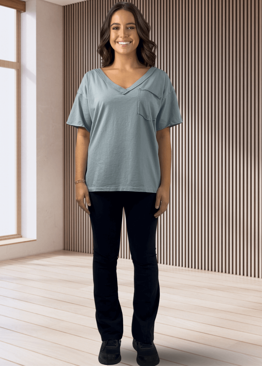 This Made in USA Slate Blue T-Shirt offers a relaxed fit made from soft, 100% cotton medium-weight fabric that is garment washed for lasting comfort. Featuring a raw edge detail and a convenient front pocket, this short-sleeve tee is perfect for everyday wear.