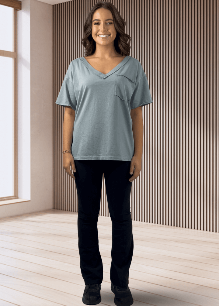 This Made in USA Slate Blue T-Shirt offers a relaxed fit made from soft, 100% cotton medium-weight fabric that is garment washed for lasting comfort. Featuring a raw edge detail and a convenient front pocket, this short-sleeve tee is perfect for everyday wear.
