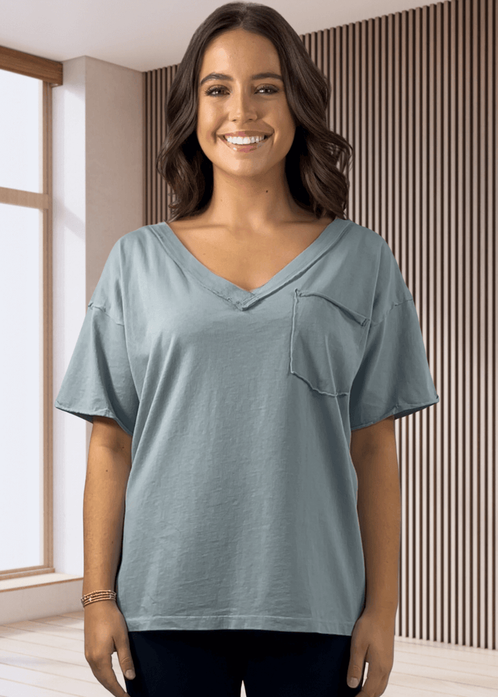 This Made in USA Slate Blue T-Shirt offers a relaxed fit made from soft, 100% cotton medium-weight fabric that is garment washed for lasting comfort. Featuring a raw edge detail and a convenient front pocket, this short-sleeve tee is perfect for everyday wear.