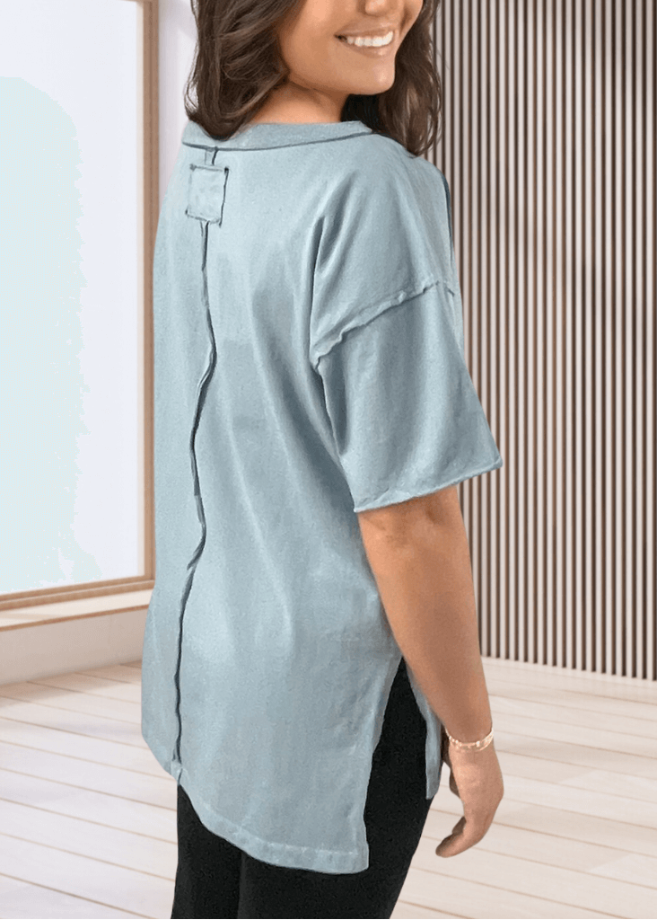 This Made in USA Slate Blue T-Shirt offers a relaxed fit made from soft, 100% cotton medium-weight fabric that is garment washed for lasting comfort. Featuring a raw edge detail and a convenient front pocket, this short-sleeve tee is perfect for everyday wear.