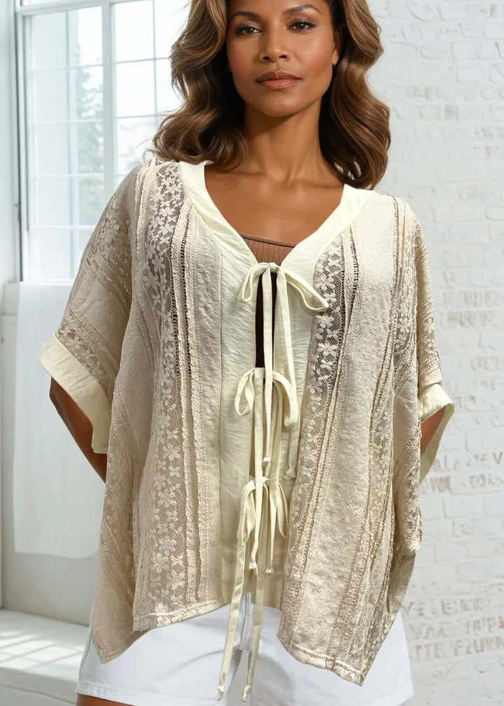 Elevate your wardrobe with this charming Daisy Lace Tie Front Top in cream, crafted right here in the USA. The oversized silhouette features delicate floral lace with a flattering V-neckline and three functional front ties for customizable styling. 