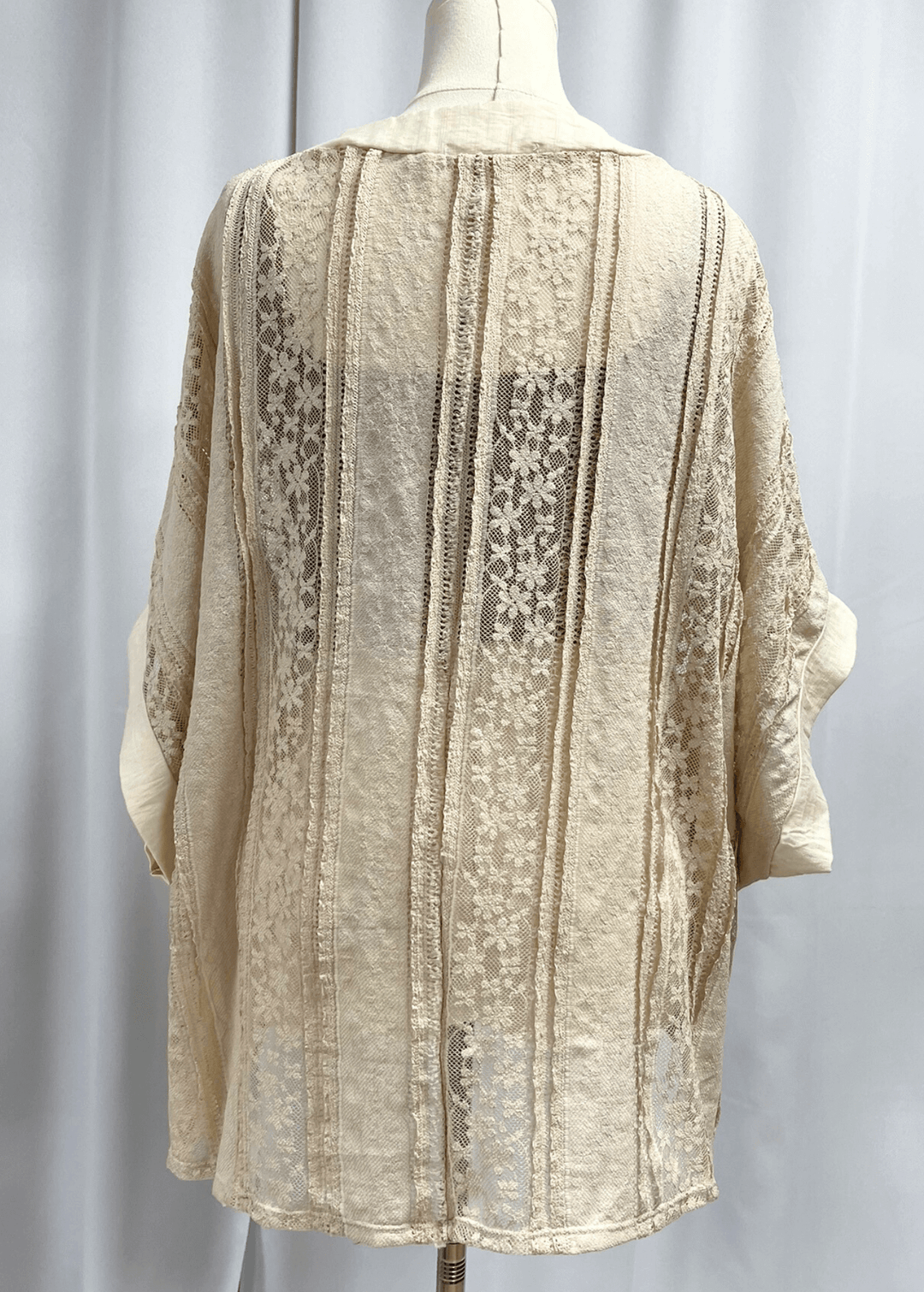 Elevate your wardrobe with this charming Daisy Lace Tie Front Top in cream, crafted right here in the USA. The oversized silhouette features delicate floral lace with a flattering V-neckline and three functional front ties for customizable styling. 