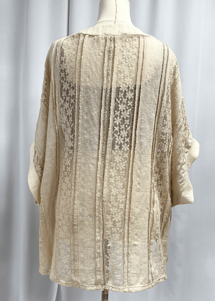 Elevate your wardrobe with this charming Daisy Lace Tie Front Top in cream, crafted right here in the USA. The oversized silhouette features delicate floral lace with a flattering V-neckline and three functional front ties for customizable styling. 