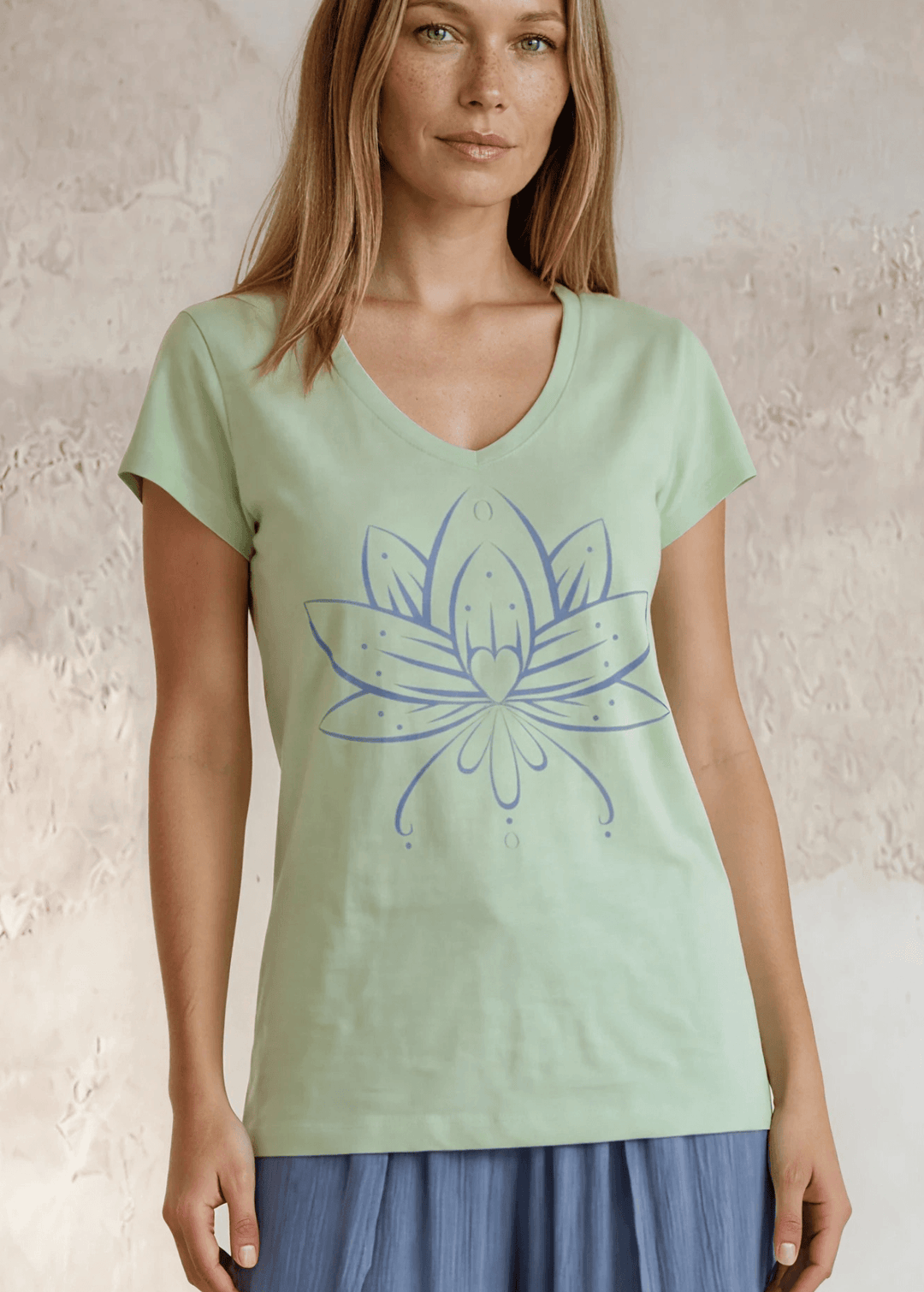 Shop the Meghan Tee — a garment-dyed, fitted scoop neck tee in Neil Green with a Denim Blue Flower Graphic. 50% cotton / 50% modal, ultra-soft. Made in USA.