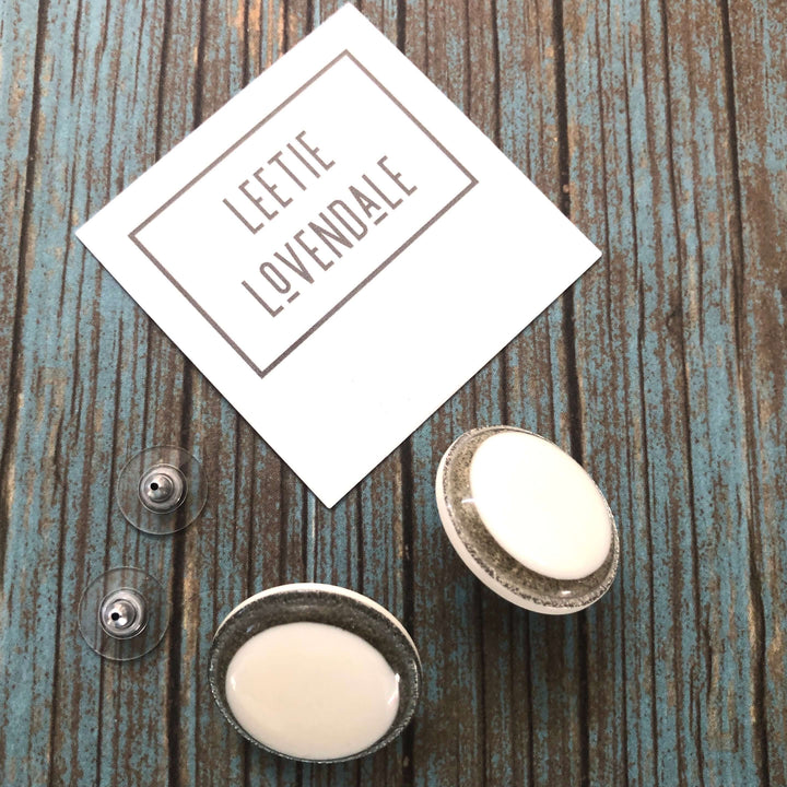 Vintage beveled disc studs in white resin &amp; silver glitter, 24mm. Surgical steel posts, lightweight. 1960s Lucite, handcrafted in the USA.