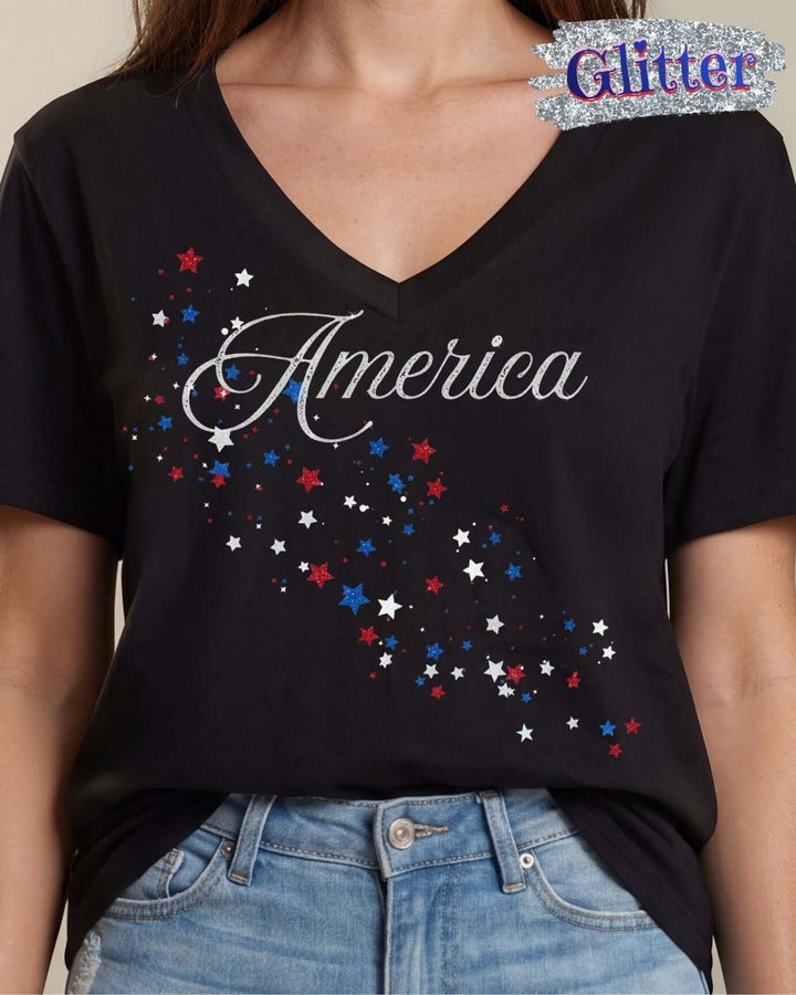 Glitter America script with cascading red, white &amp; blue stars on a black V-neck tee. 100% cotton, USA-milled fabric, made in USA. Perfect for 4th of July.