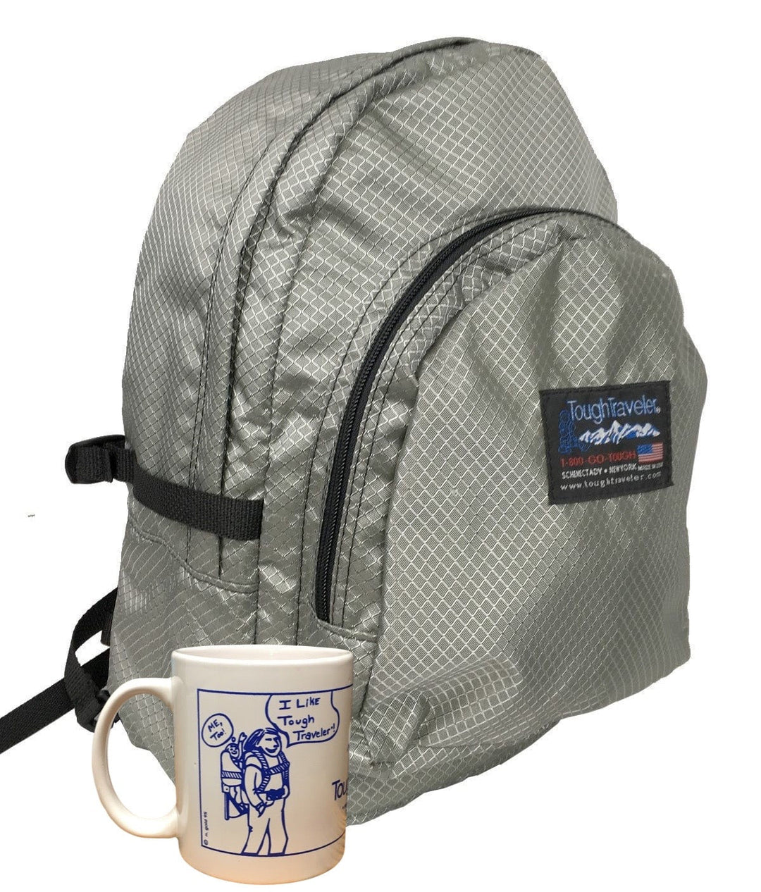 Made in USA, silver diamond diaper bag backpack with front zip pocket shown next to a coffee mug for size