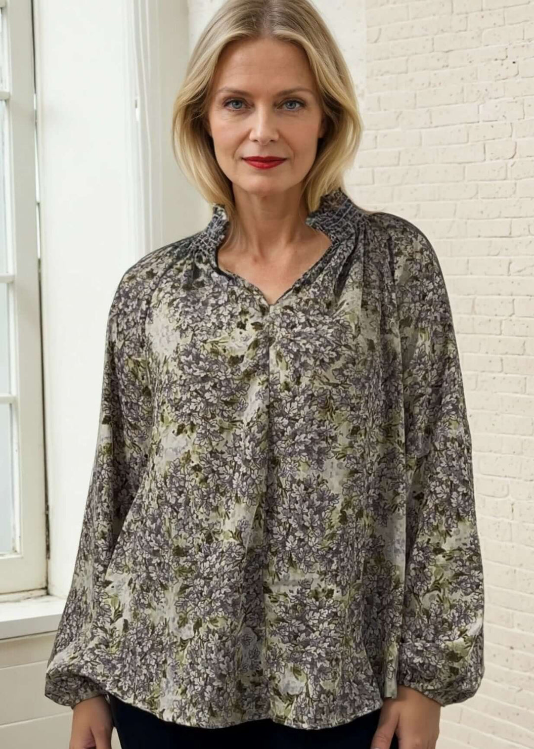 The USA made Ava Mock Stand Collar Blouse features a delicate smocked high collar with a split neckline, adding subtle sophistication to your wardrobe. Designed with long puff sleeves and elasticized cuffs, it offers both comfort and refined style