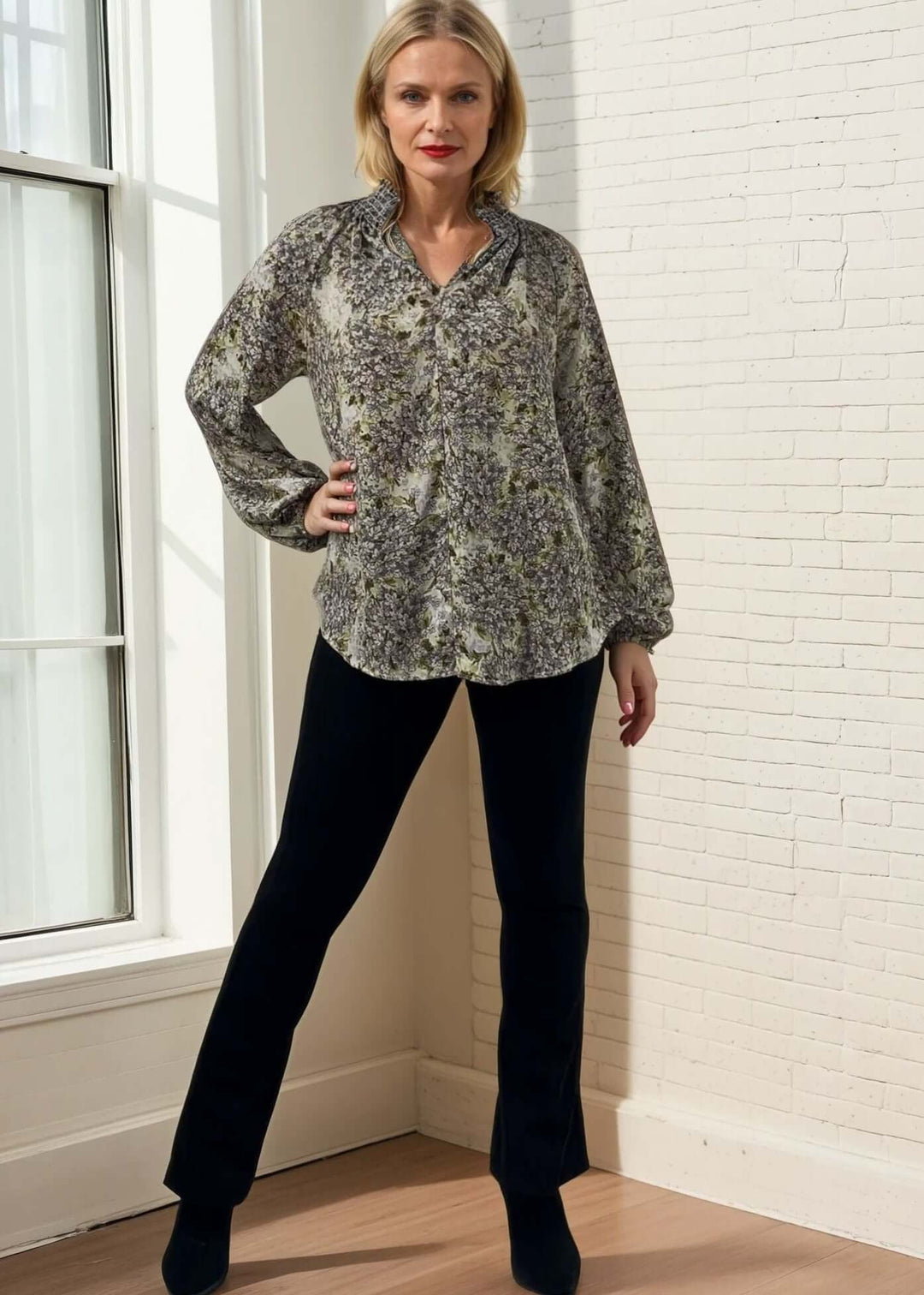 The USA made Ava Mock Stand Collar Blouse features a delicate smocked high collar with a split neckline, adding subtle sophistication to your wardrobe. Designed with long puff sleeves and elasticized cuffs, it offers both comfort and refined style