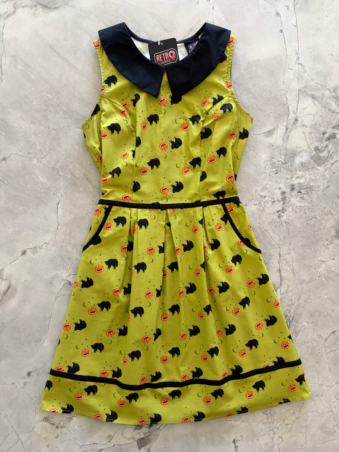 Made in USA. Shop the Black Cat Collared Dress by Retrolicious in 100% cotton, with a Peter Pan collar, contrast piping, A-line skirt and pockets.