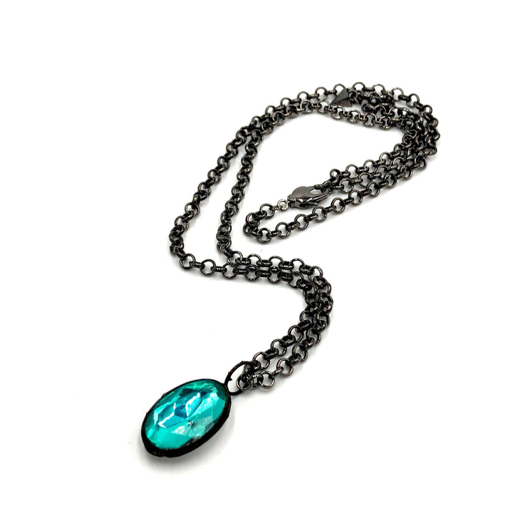 Teal faceted oval pendant, hand-wrought with vintage components on a gun metal chain. 3 lengths available. Limited edition, made in USA.