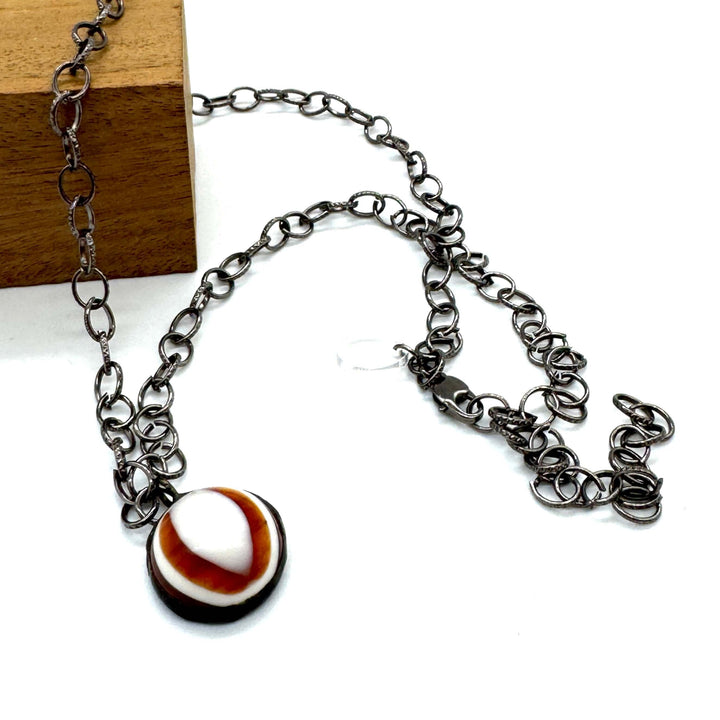 Hand-wrought tortoise bullseye pendant on a 26" hypoallergenic gun metal chain. Limited edition, adjustable, made in USA. Perfect for layering.