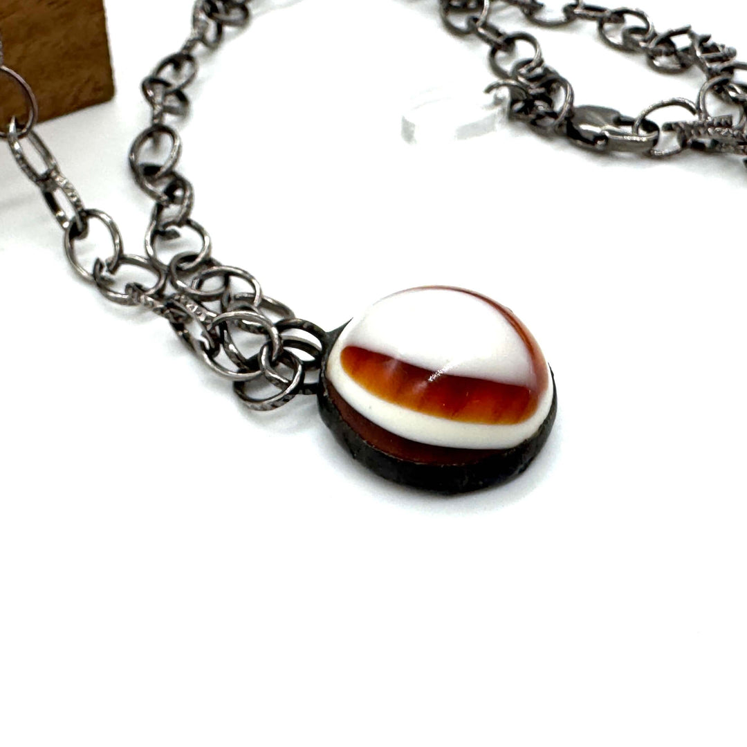 Hand-wrought tortoise bullseye pendant on a 26" hypoallergenic gun metal chain. Limited edition, adjustable, made in USA. Perfect for layering.