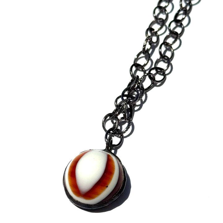 Hand-wrought tortoise bullseye pendant on a 26" hypoallergenic gun metal chain. Limited edition, adjustable, made in USA. Perfect for layering.