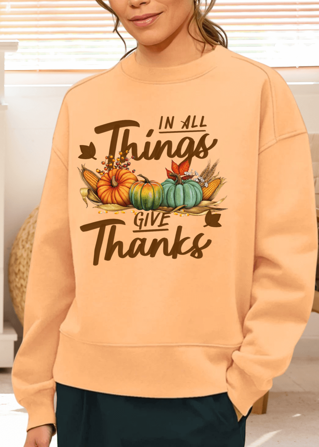 Embrace cozy fall vibes with this heavyweight apricot sweatshirt, featuring the heartfelt "In All Things - Give Thanks" graphic. Made in the USA from soft cotton-polyester blend
