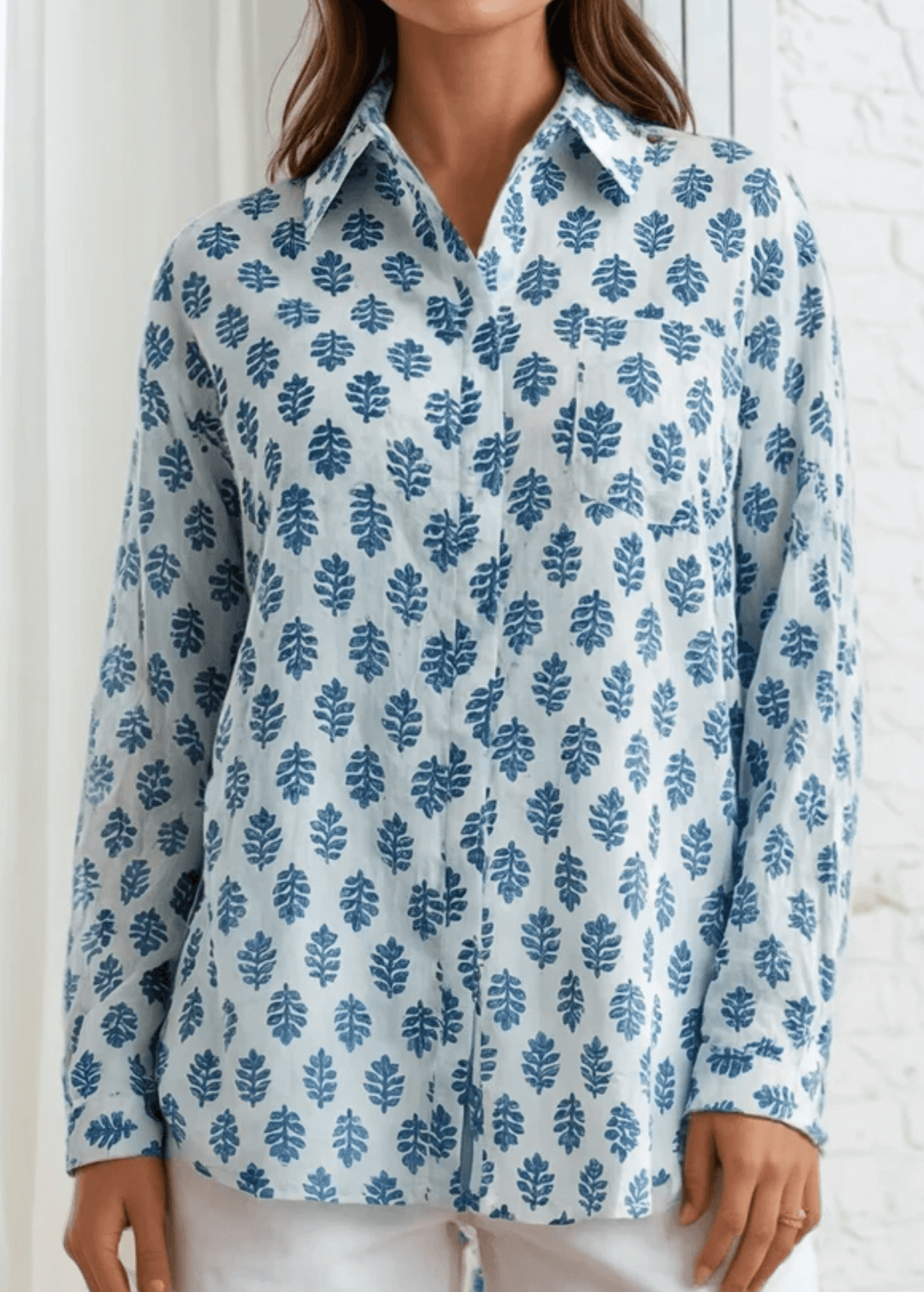 Effortless elegance meets everyday comfort in this Made in USA vintage-washed cotton-voile button-down. Hand-block inspired indigo florals dance across a serene sky-blue canvas, creating a timeless aesthetic that transitions seamlessly from casual to polished. The lightweight, breathable 100% cotton construction keeps you cool and comfortable.