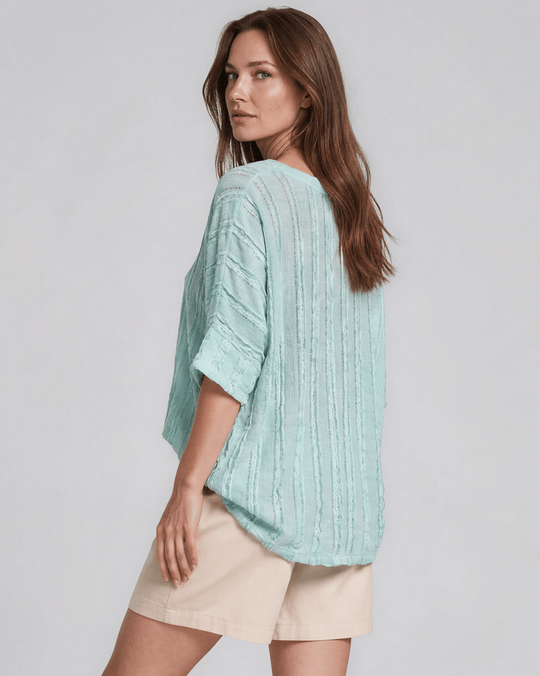 Shop the Laurel Textured Top in Aqua Blue — a relaxed oversized v-neck with striped lace effect, contrast sleeve bands &amp; side slit. Made in USA.