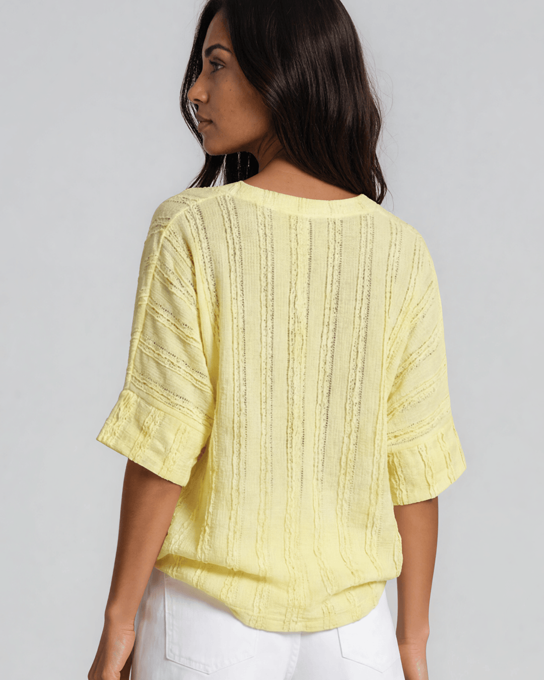 Shop the Laurel Textured Top in Yellow — a relaxed oversized v-neck with striped lace effect, contrast sleeve bands &amp; side slit. Made in USA.