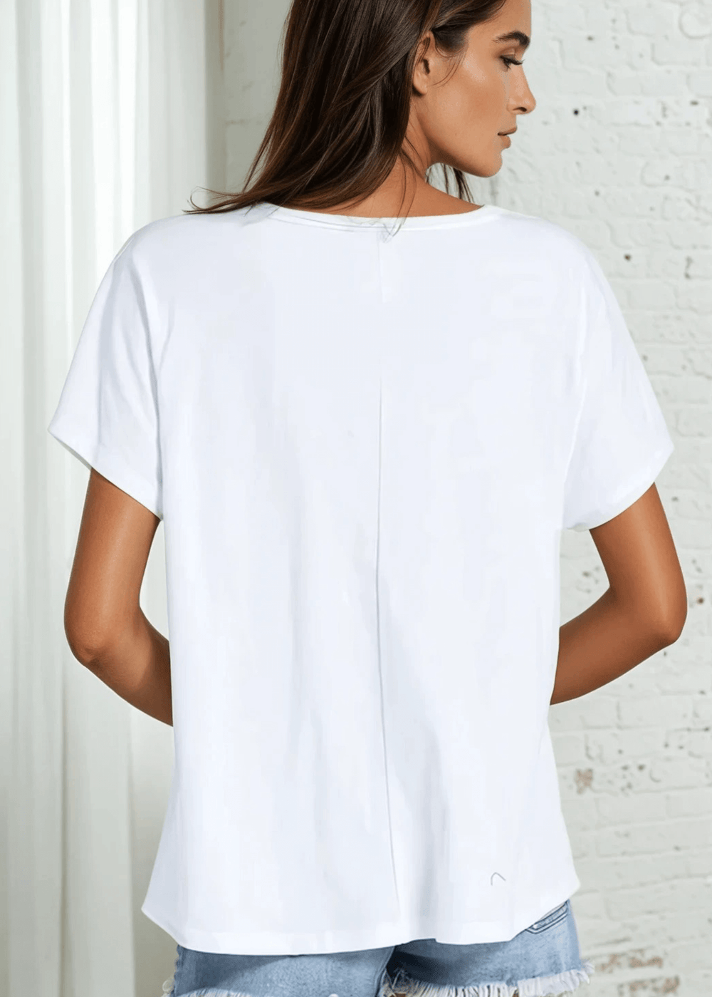 Effortlessly chic and breathable, the Lara Laced Up Cut Out Top in Bright White combines a flattering oversized silhouette with a striking V-neck cutout and delicate laced-up detailing. Crafted in the USA from 100% cotton