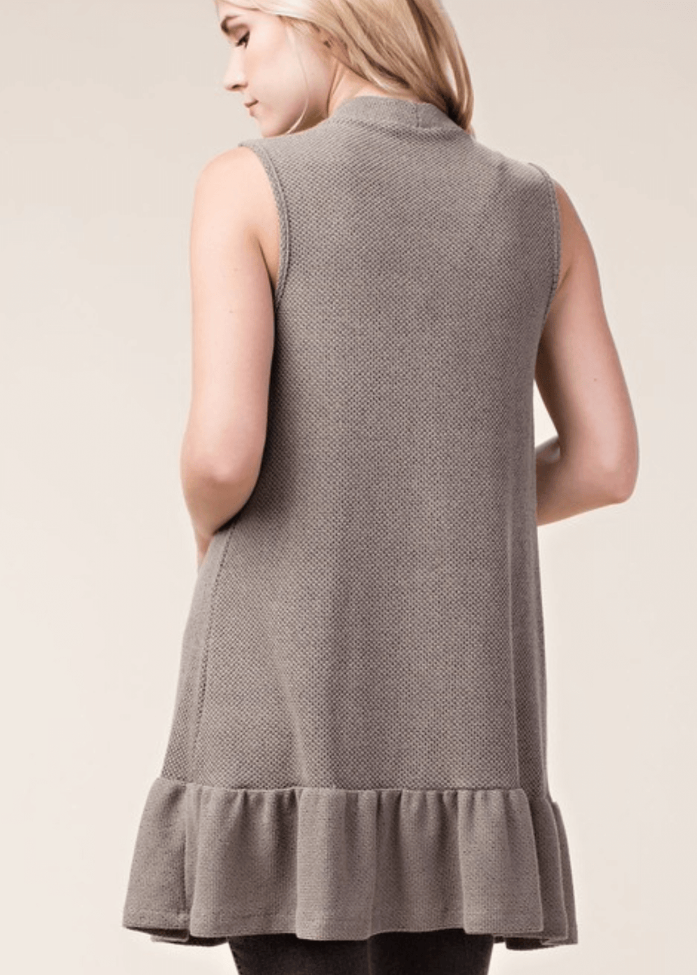 The Monica Open Front Ruffled Knit Accent Vest is your go-to layering piece for effortless style. This sleeveless cardigan vest features a charming flounce ruffle hem that adds movement and dimension to any outfit. 