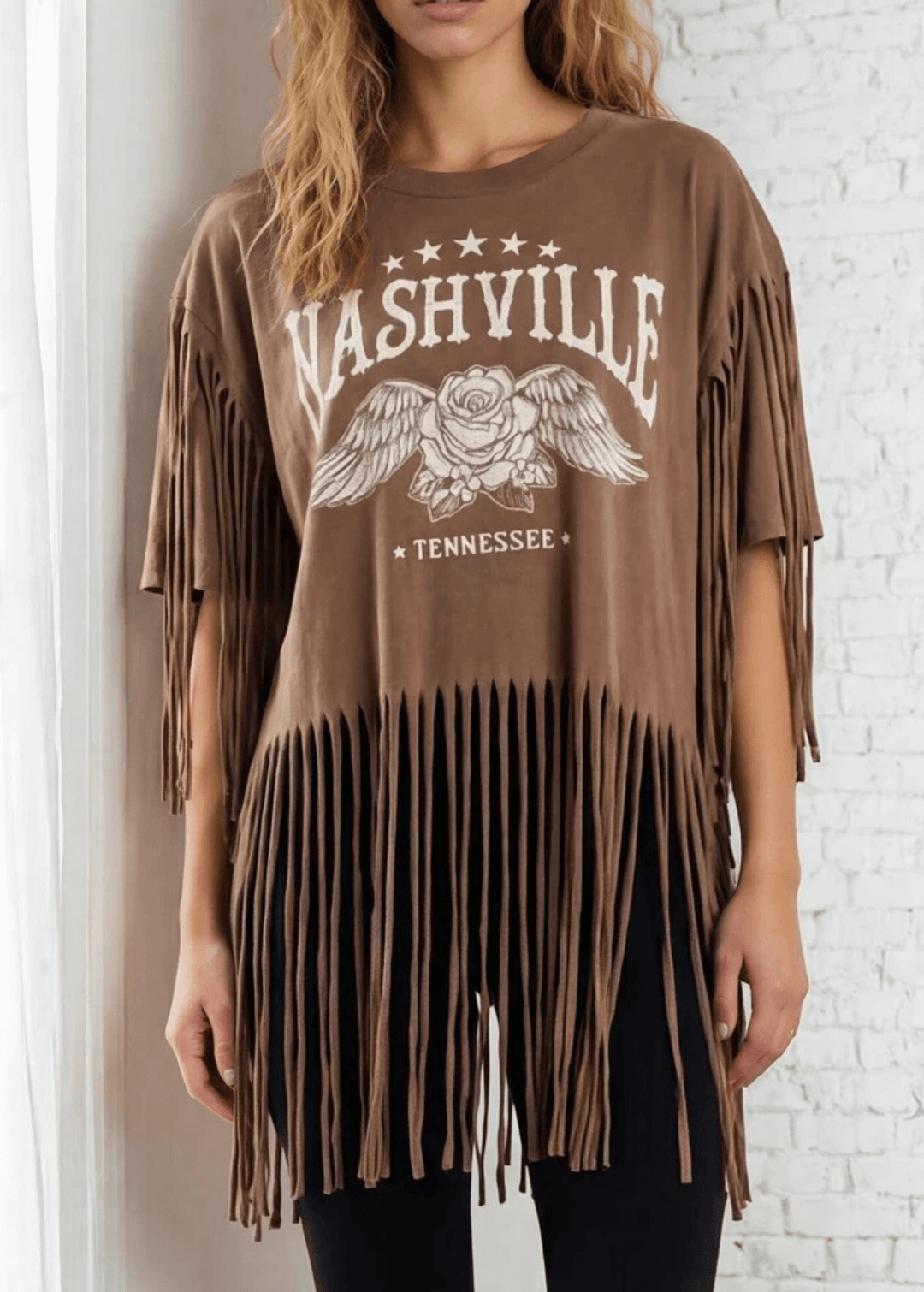The Farrah Fringe Nashville Top brings effortless style to your everyday wardrobe. Featuring playful fringe detailing and a relaxed silhouette, this versatile piece pairs beautifully with jeans, leggings, or your favorite bottoms. The soft cotton-blend fabric with a touch of spandex offers comfort and gentle stretch, while the round neckline and short sleeves keep things casual and chic. Perfect for layering or wearing solo, this made-in-USA top is a wardrobe essential that works from season to season. 
