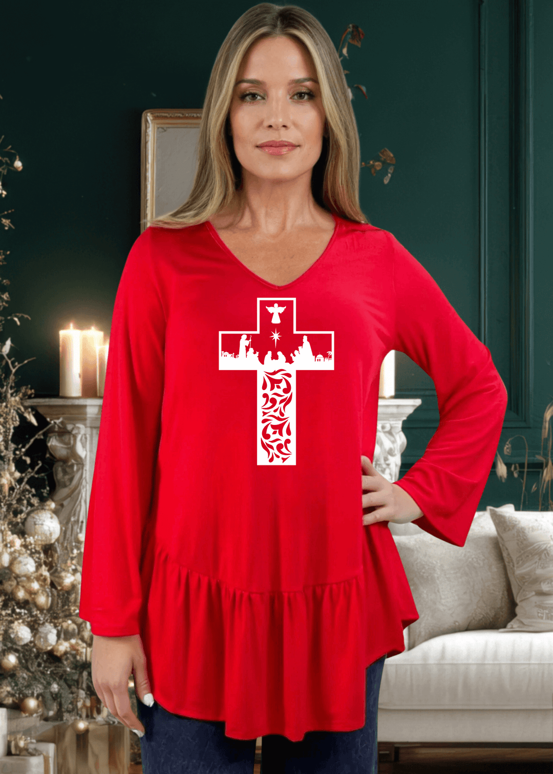 Celebrate the season with this charming nativity scene cross graphic tunic, expertly crafted in the USA. The relaxed silhouette features a flattering V-neckline, voluminous flare sleeves, and an asymmetrical hemline accented with a delicate flounce ruffle.  Available in Red, Green and Navy