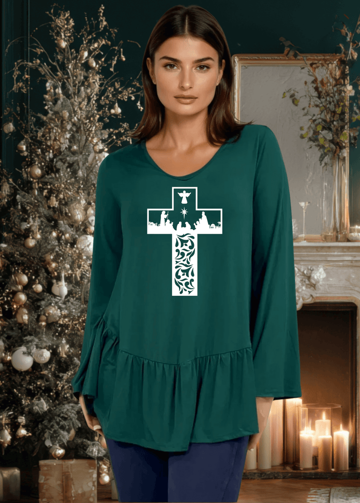 Celebrate the season with this charming nativity scene cross graphic tunic, expertly crafted in the USA. The relaxed silhouette features a flattering V-neckline, voluminous flare sleeves, and an asymmetrical hemline accented with a delicate flounce ruffle.  Available in Red, Green and Navy