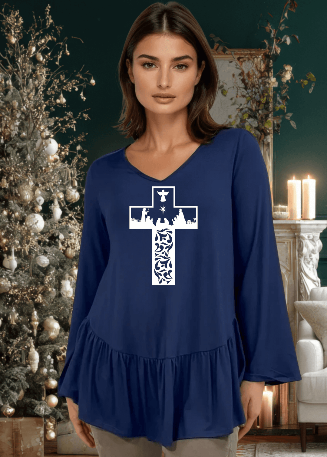 Celebrate the season with this charming nativity scene cross graphic tunic, expertly crafted in the USA. The relaxed silhouette features a flattering V-neckline, voluminous flare sleeves, and an asymmetrical hemline accented with a delicate flounce ruffle.  Available in Red, Green and Navy