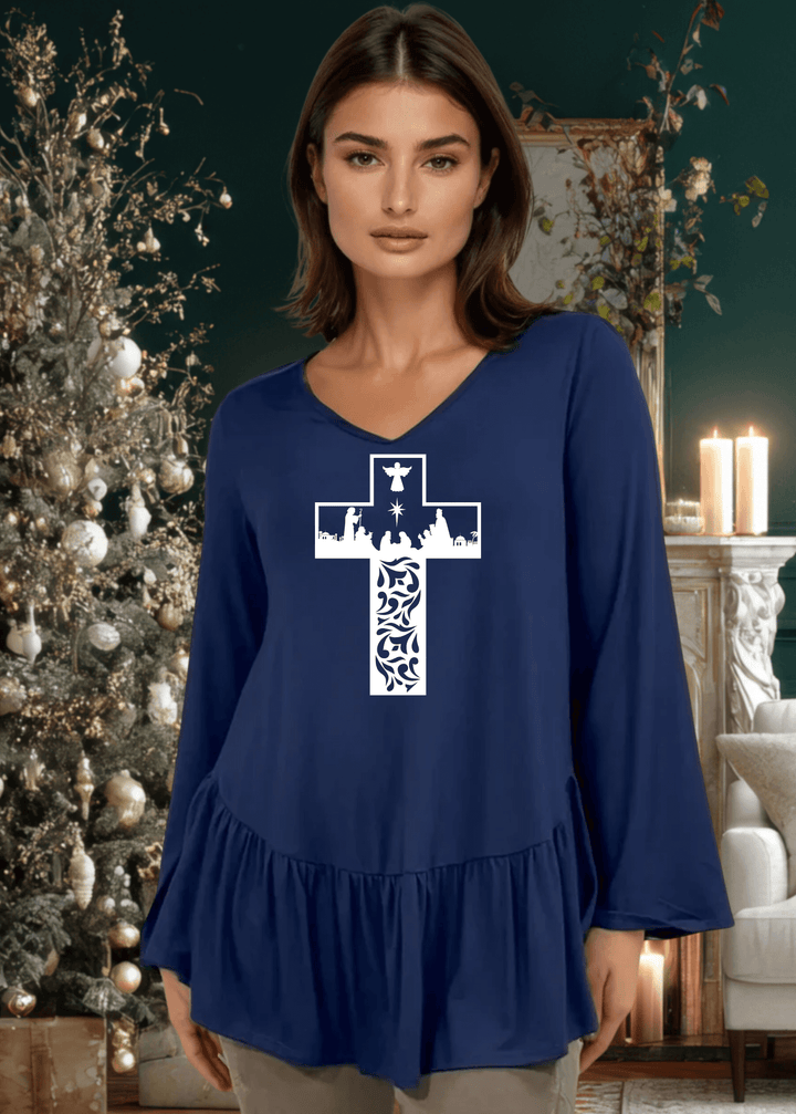 Celebrate the season with this charming nativity scene cross graphic tunic, expertly crafted in the USA. The relaxed silhouette features a flattering V-neckline, voluminous flare sleeves, and an asymmetrical hemline accented with a delicate flounce ruffle.  Available in Red, Green and Navy