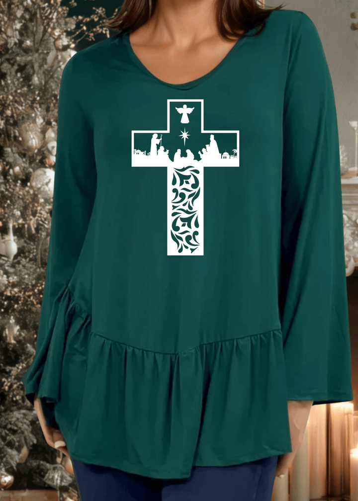 Celebrate the season with this charming nativity scene cross graphic tunic, expertly crafted in the USA. The relaxed silhouette features a flattering V-neckline, voluminous flare sleeves, and an asymmetrical hemline accented with a delicate flounce ruffle.  Available in Red, Green and Navy