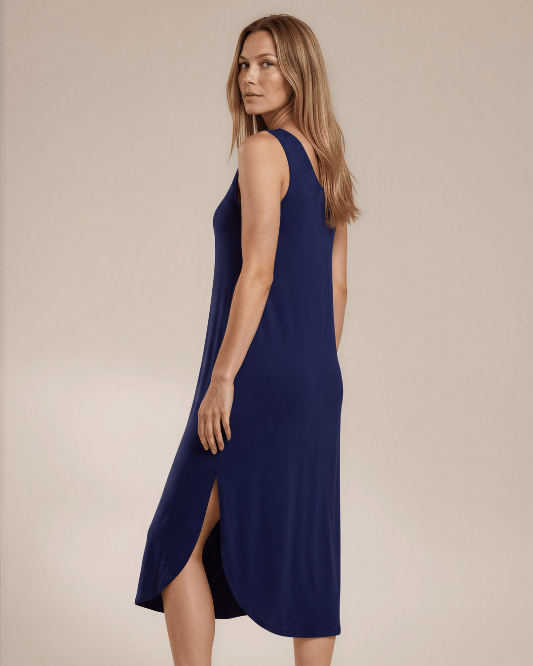 Sammie Sleeveless Midi Dress in navy blue. Relaxed fit, scoop neck, side pockets &amp; slits. 95% Rayon, 5% Spandex. Made in USA.
