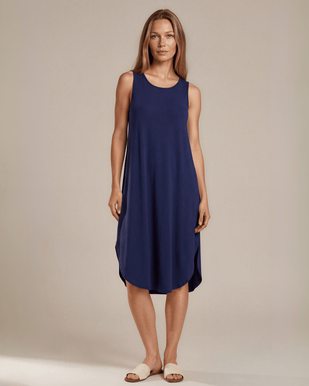 Sammie Sleeveless Midi Dress in navy blue. Relaxed fit, scoop neck, side pockets &amp; slits. 95% Rayon, 5% Spandex. Made in USA.