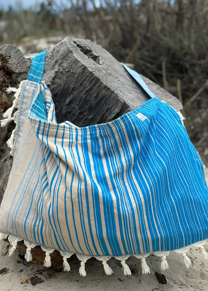Shop the Beachables Striped 3-in-1 Turkish Cotton Beach Bag – converts from bag to towel to chair cover. Sand-resistant, quick-dry, machine washable. Made in USA.